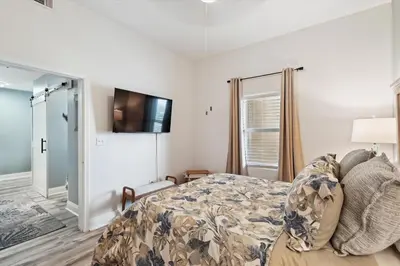 a bedroom with a bed and a tv on the wall at Laketown Wharf 2123 condo in Panama City Beach