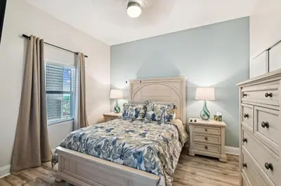 a bedroom with a bed and a window at Laketown Wharf 2123 condo in Panama City Beach