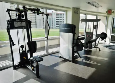 a gym with several tread machines in a building at Laketown Wharf 2123 condo in Panama City Beach