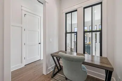 a dining room with a wooden table and a chair at White Sand Retreat by 30A Escapes in Seagrove Beach
