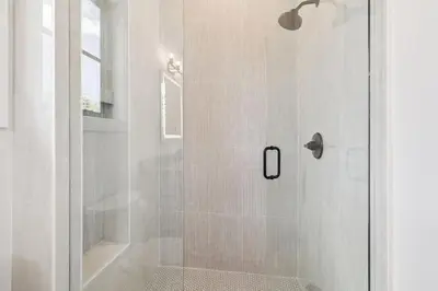 a shower with a glass door in a bathroom at White Sand Retreat by 30A Escapes in Seagrove Beach