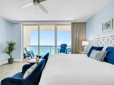a bedroom with a large bed and a balcony at New BeachFront-Majestic Beach Resort-Starbucks in Panama City Beach