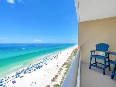 a room with a balcony with a view of the beach at New BeachFront-Majestic Beach Resort-Starbucks in Panama City Beach