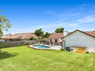 a backyard with a pool and a fence at Salt Water POOL, GAME room, KING BED &PET friendly in Panama City