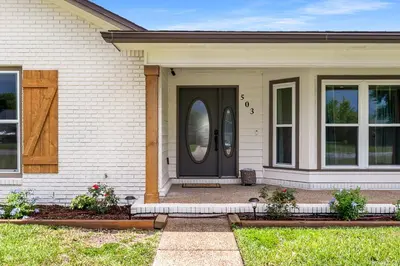 a house with a black door and windows at Salt Water POOL, GAME room, KING BED &PET friendly in Panama City