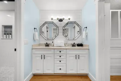 a white bathroom with a sink and two mirrors at Salt Water POOL, GAME room, KING BED &PET friendly in Panama City