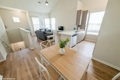 a living room with a table and a couch at 3 Bedroom Luxury Condo with Resort Pool, Game Room, and Gym in Panama City Beach