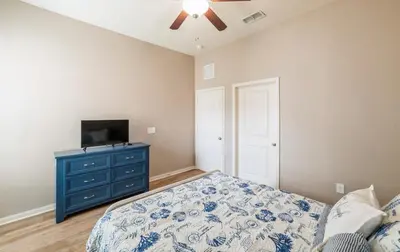 a bedroom with a bed and a tv on a dresser at 3 Bedroom Luxury Condo with Resort Pool, Game Room, and Gym in Panama City Beach