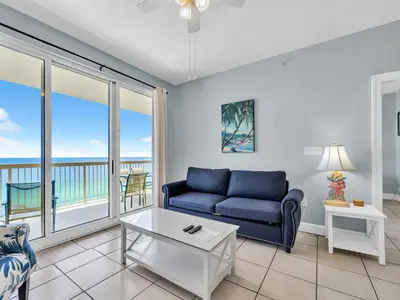 a living room with a couch and a table at Sunrise Beach #1707 in Panama City Beach