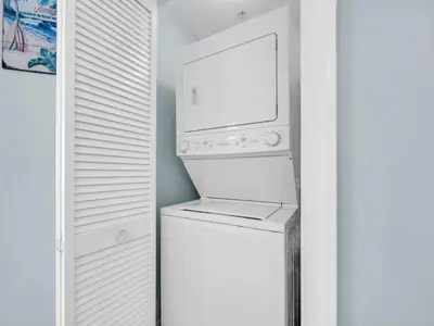 a white laundry room with a washer and dryer at Sunrise Beach #1707 in Panama City Beach