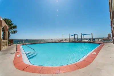 a large swimming pool with a playground at Sunrise Beach #1707 in Panama City Beach