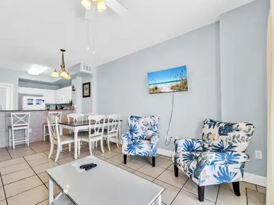 a living room with two chairs and a table at Sunrise Beach #1707 in Panama City Beach