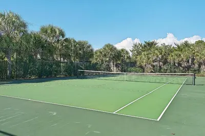 a tennis court with a net on top of it at Celadon 203 in Panama City Beach