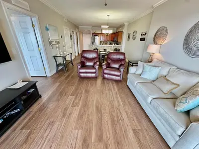 a living room with a couch and two chairs at Tropic Winds 2108 in Panama City Beach