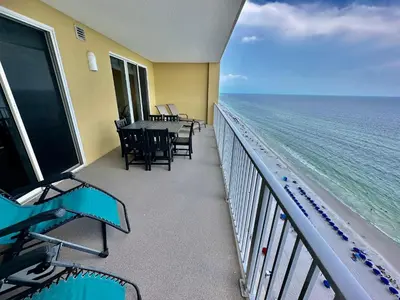 a balcony with a table and chairs and the ocean at Tropic Winds 2108 in Panama City Beach