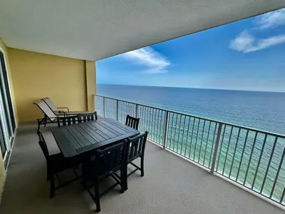a balcony with a table and chairs and the ocean at Tropic Winds 2108 in Panama City Beach
