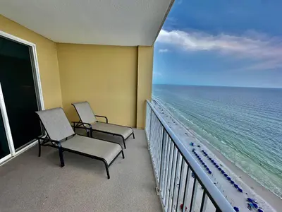 two chairs on a balcony looking out at the ocean at Tropic Winds 2108 in Panama City Beach