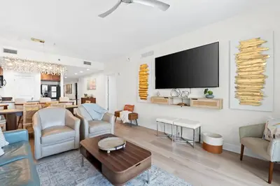 a living room with a flat screen tv on a wall at Sterling Breeze Unit 2106 in Panama City Beach