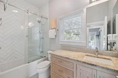 a bathroom with a toilet and a shower and a sink at 90 N Cartagena Carriage House by 30A Escapes in Rosemary Beach
