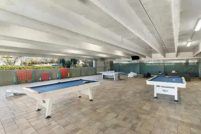 two ping pong tables in a large room at Emerald Beach Resort 1734 - Amazing Views, Beachfront, King Bed, 3 Pools, Starbucks in Panama City Beach