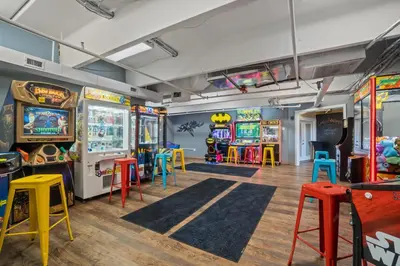 a room with arcade games and colorful stools at Emerald Beach Resort 1734 - Amazing Views, Beachfront, King Bed, 3 Pools, Starbucks in Panama City Beach