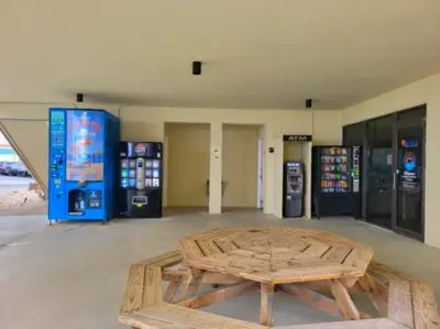 a room with a wooden table and two gas pumps at Sunbird Resort - 11th Floor - Free Beach Chairs - by Sunbird Rentals in Panama City Beach