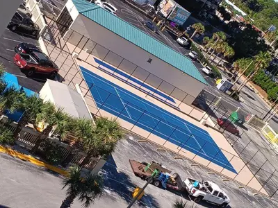an overhead view of a building with a swimming pool at Sunbird Resort - 11th Floor - Free Beach Chairs - by Sunbird Rentals in Panama City Beach