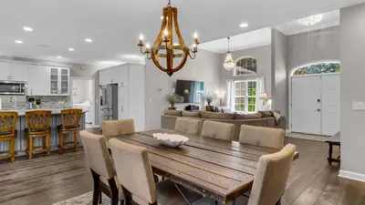 a kitchen and living room with a wooden table and chairs at Secluded Sanctuary By the Sea in Seacrest
