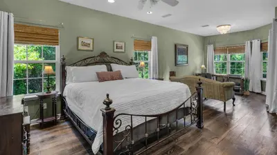 a bedroom with a large bed and windows at Secluded Sanctuary By the Sea in Seacrest