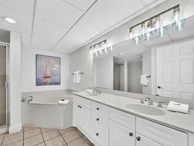 a white bathroom with a sink and a mirror at Emerald Beach 2336 by Emerald Coast Retreats in Panama City Beach