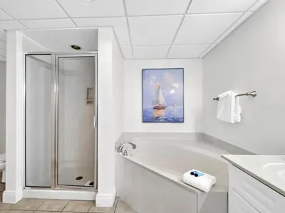 a white bathroom with a tub and a shower at Emerald Beach 2336 by Emerald Coast Retreats in Panama City Beach