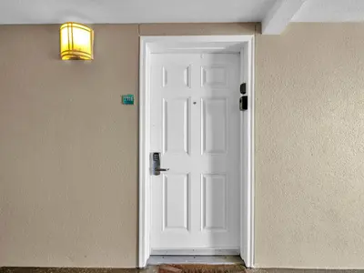 a white door in a room with a light at Emerald Beach 2336 by Emerald Coast Retreats in Panama City Beach