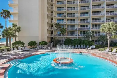 a pool with a fountain in front of a hotel at Shores of Panama 816 by Emerald Coast Retreats in Panama City Beach