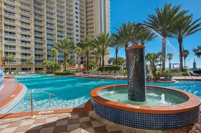 a swimming pool at a resort with a fountain at Shores of Panama 816 by Emerald Coast Retreats in Panama City Beach