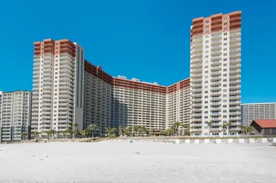 a hotel on the beach in front of a building at Shores of Panama 816 by Emerald Coast Retreats in Panama City Beach