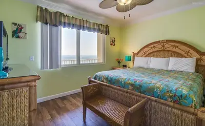 a bedroom with a large bed and a window at Shores of Panama 816 by Emerald Coast Retreats in Panama City Beach