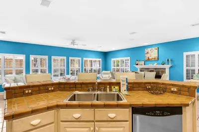 a kitchen with a sink and blue walls at Little Narnia - Colorful Beach House Private Pool in Seacrest