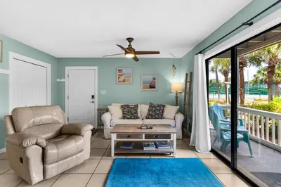 a living room with a couch and a chair at Sunny Daze at Beachwood Villas - Walk to Beach Outdoor Pools & More in Santa Rosa Beach