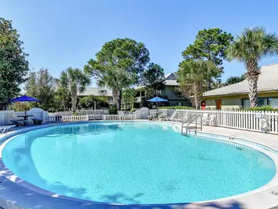 a large pool with blue water in front of a house at Sunny Daze at Beachwood Villas - Walk to Beach Outdoor Pools & More in Santa Rosa Beach