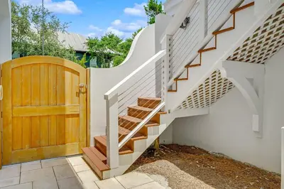 a staircase in a home with a wooden door at Pinecrest Retreat in Inlet Beach