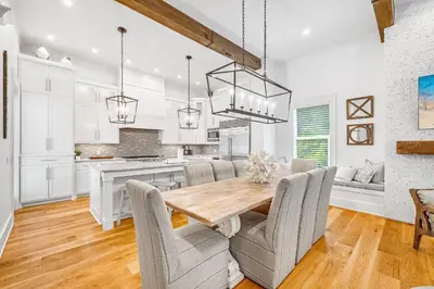 a kitchen and dining room with a wooden table and chairs at Pinecrest Retreat in Inlet Beach