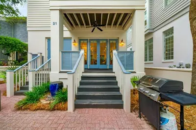 a front door of a house with blue doors at Piccadilly Cottage in Rosemary Beach