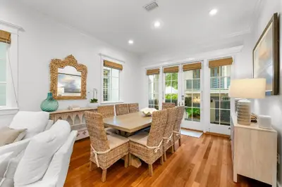 a living room with a table and chairs at Piccadilly Cottage in Rosemary Beach