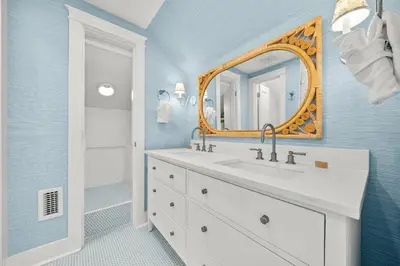 a bathroom with a sink and a mirror at Piccadilly Cottage in Rosemary Beach