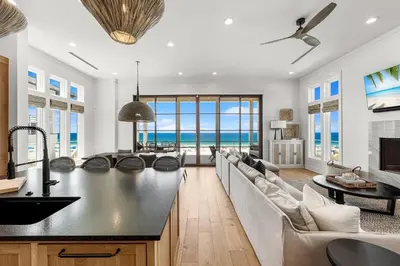 a kitchen and living room with a view of the ocean at On Deck in Panama City Beach