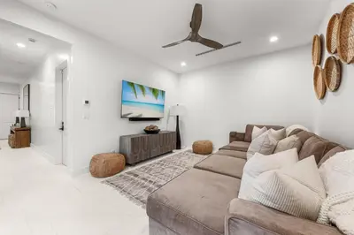 a living room with a couch and a ceiling fan at On Deck in Panama City Beach