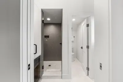 a white bathroom with a toilet and a sink at On Deck in Panama City Beach