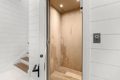 a door leading into a bathroom with stairs at On Deck in Panama City Beach
