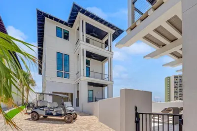 a golf cart parked in front of a house at On Deck in Panama City Beach