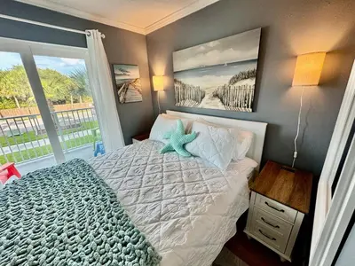 a bedroom with a bed with a starfish on it at Beach Across Street, Walk to Restaurants, 2 Pools, Beach Gear in Panama City Beach